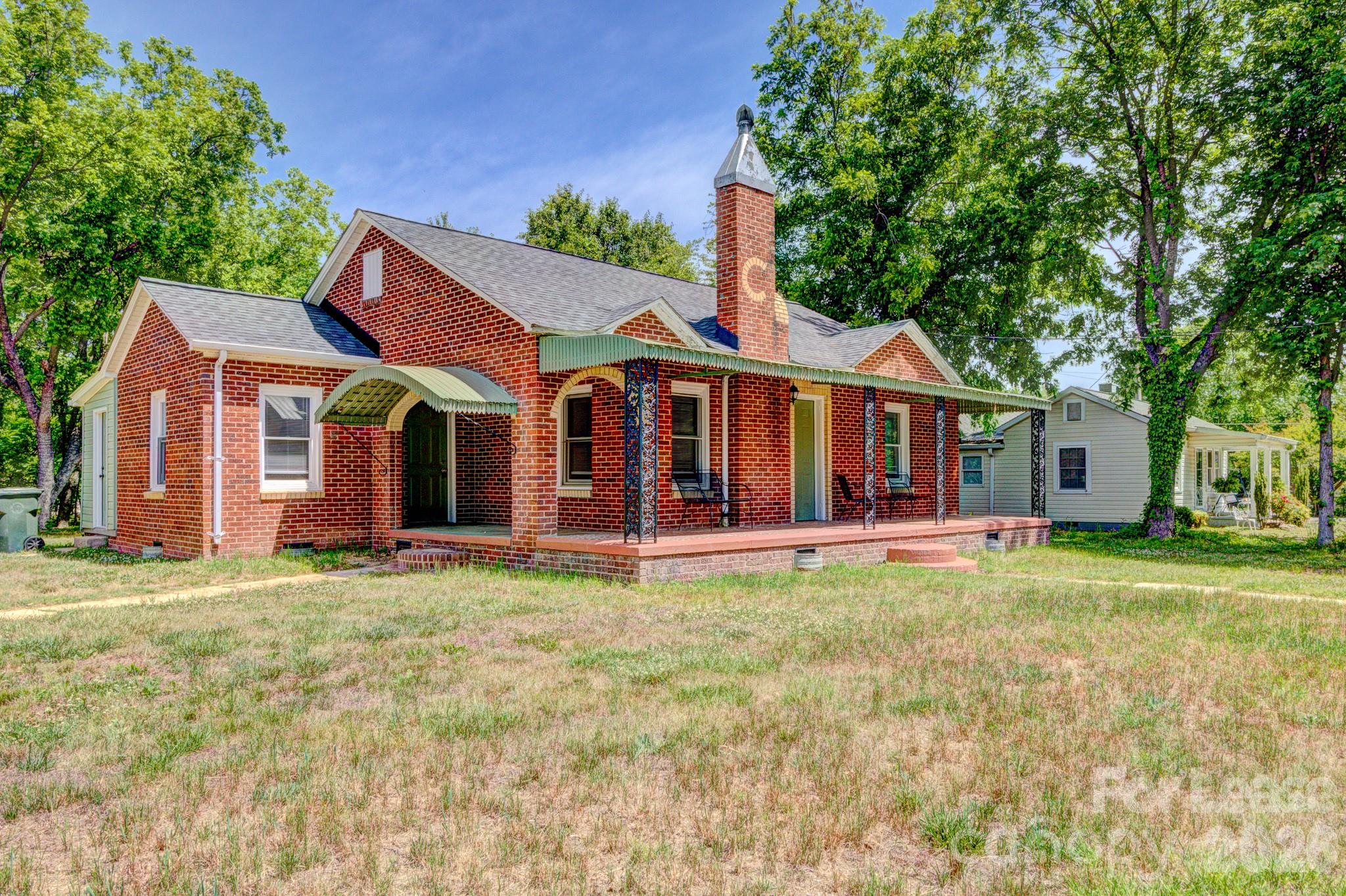 1006 Delview Road Cherryville, NC 28021 - Photo 1 of 10 a front view of a house with a garden and porch