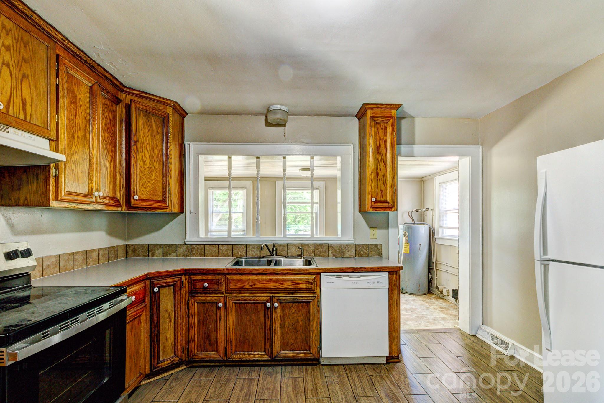 1006 Delview Road Cherryville, NC 28021 - Photo 7 of 10 a kitchen with stainless steel appliances granite countertop wooden cabinets a sink and a stove