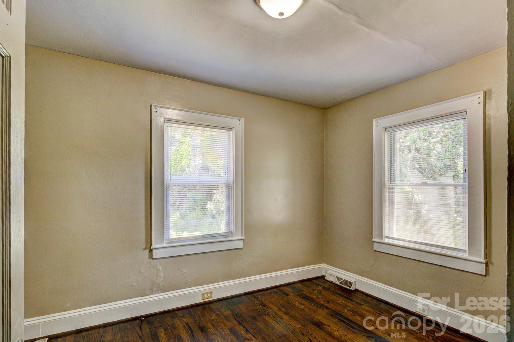 1006 Delview Road Cherryville, NC 28021 - Photo 8 of 10 a view of an empty room with wooden floor and a window