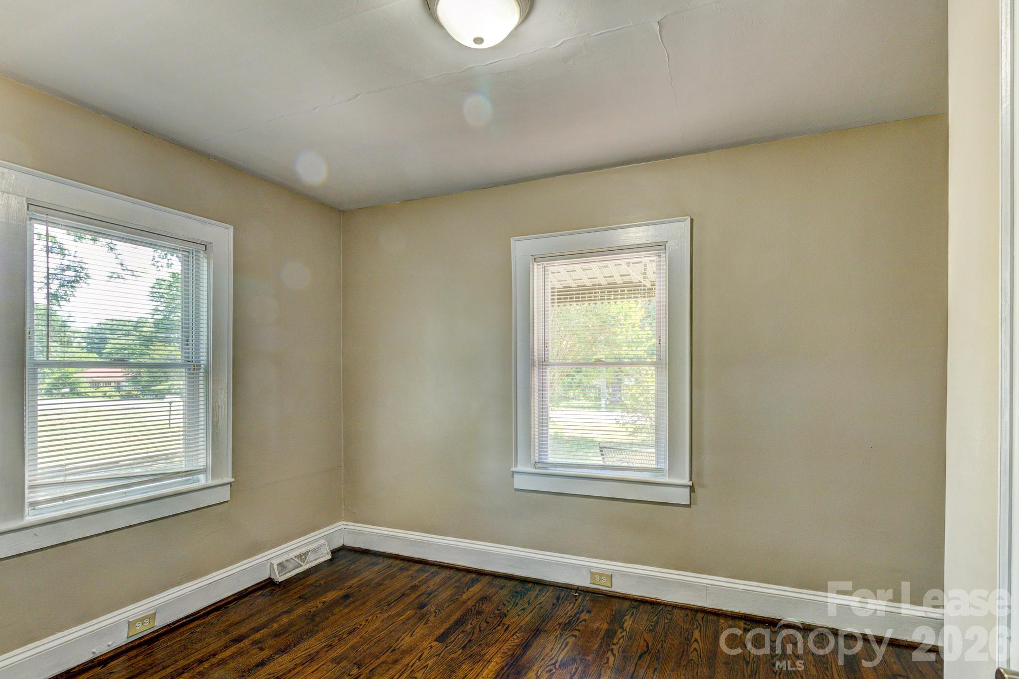 1006 Delview Road Cherryville, NC 28021 - Photo 9 of 10 a view of an empty room with wooden floor and a window