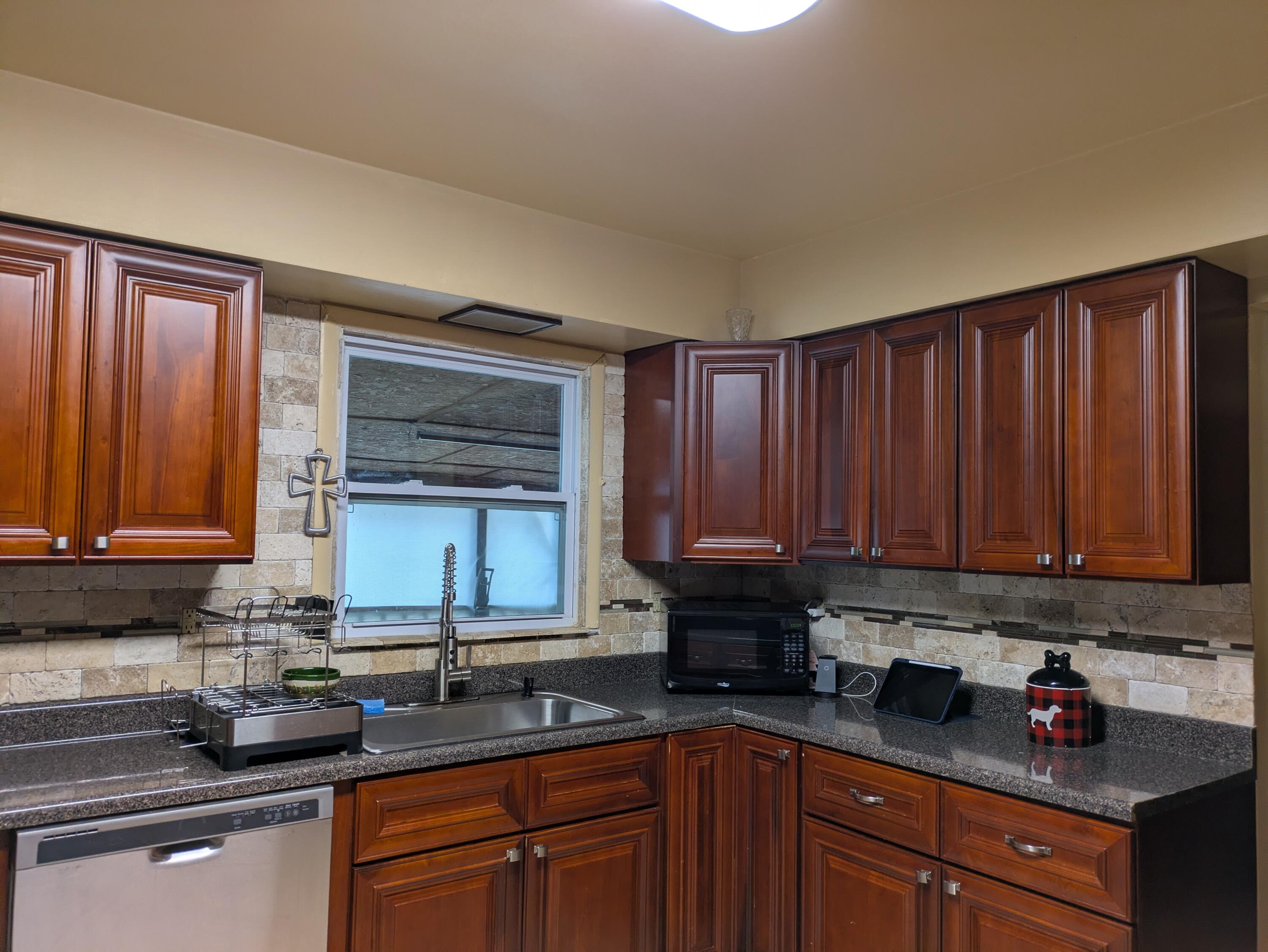 23180 Whitcomb Street Lowell, IN 46356 - Photo 11 of 22 a kitchen with granite countertop a sink cabinets and stainless steel appliances