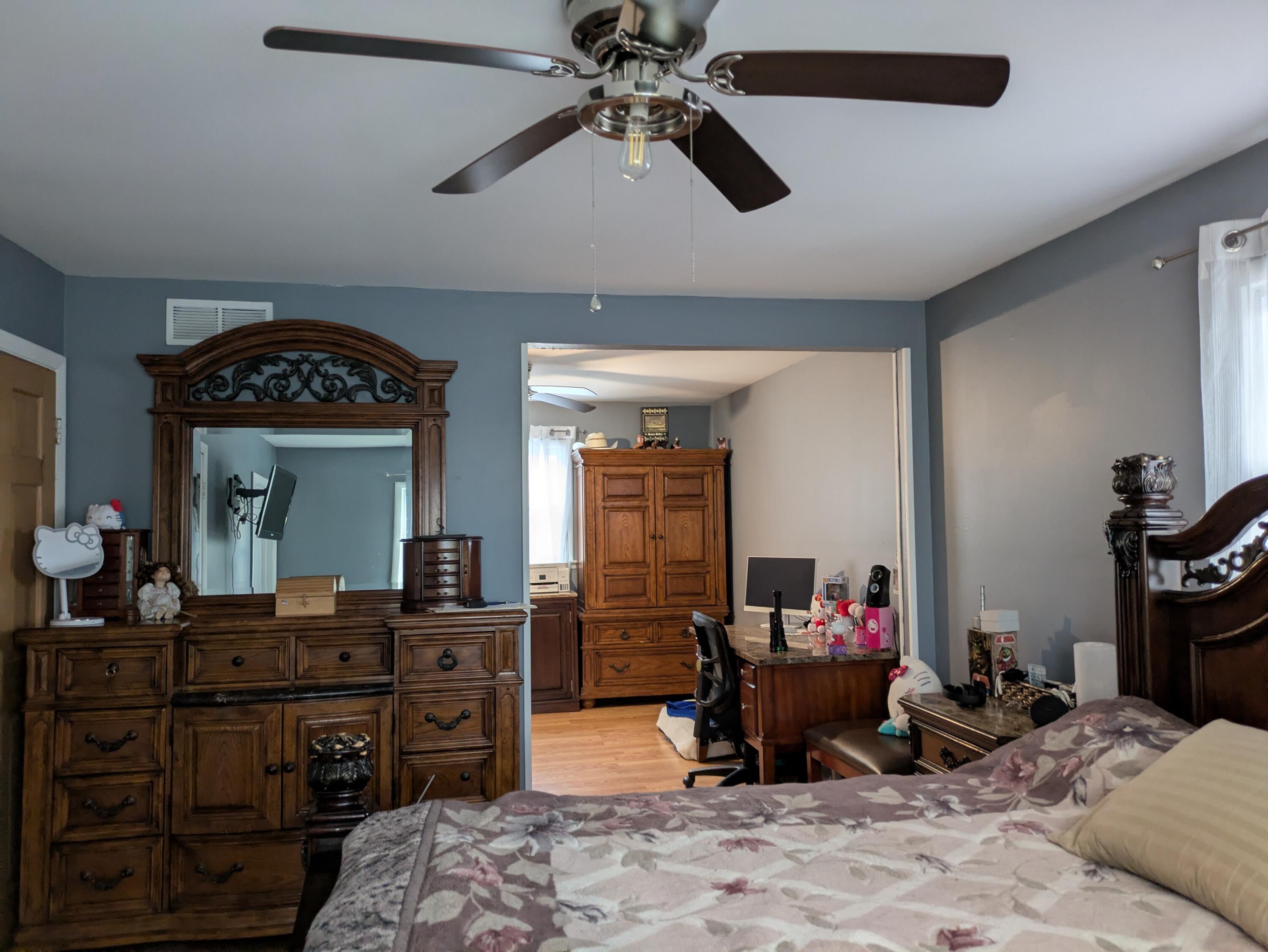 23180 Whitcomb Street Lowell, IN 46356 - Photo 14 of 22 a bedroom with a bed and wooden floor