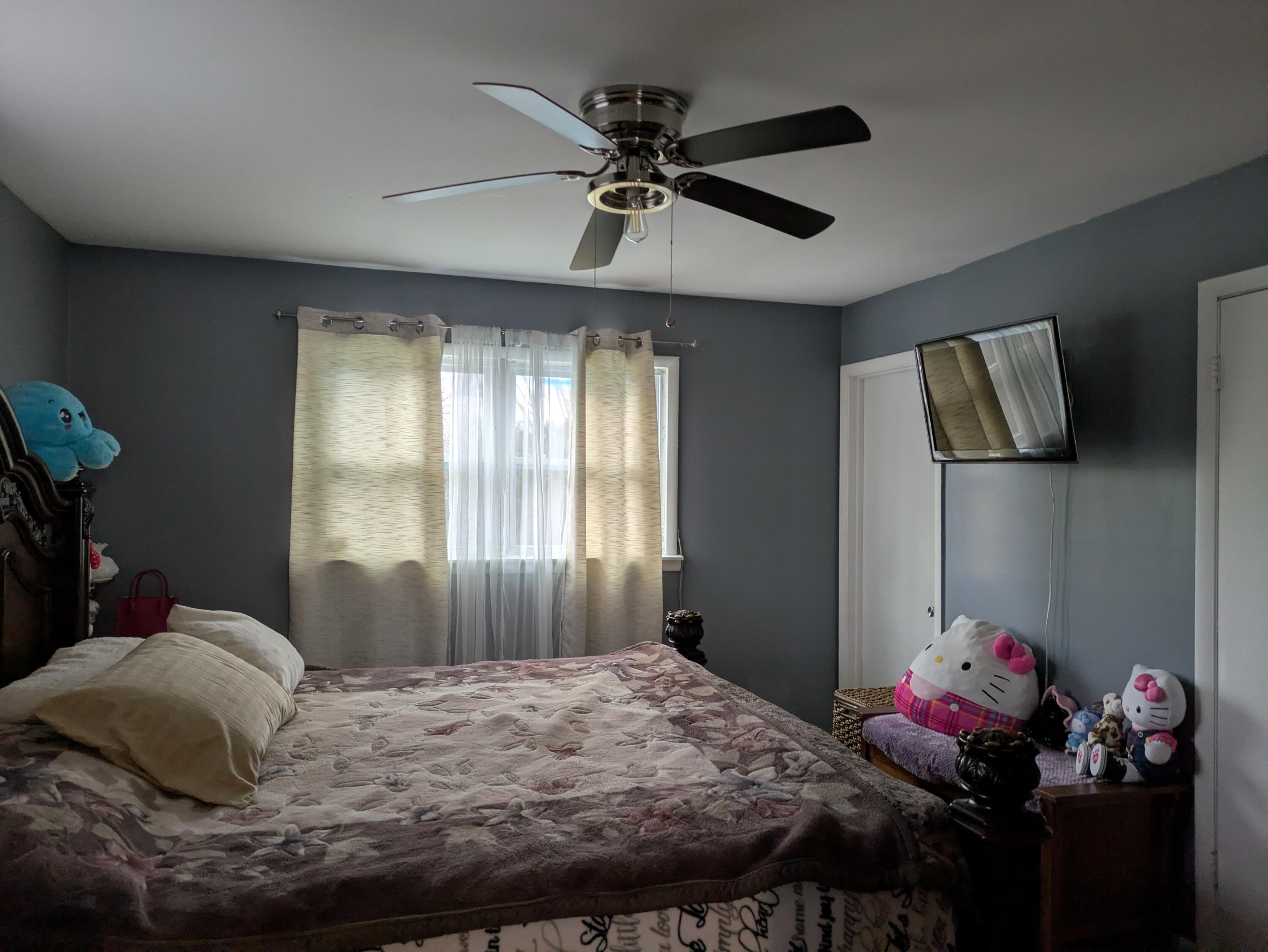 23180 Whitcomb Street Lowell, IN 46356 - Photo 15 of 22 a bedroom with a bed and a chandelier