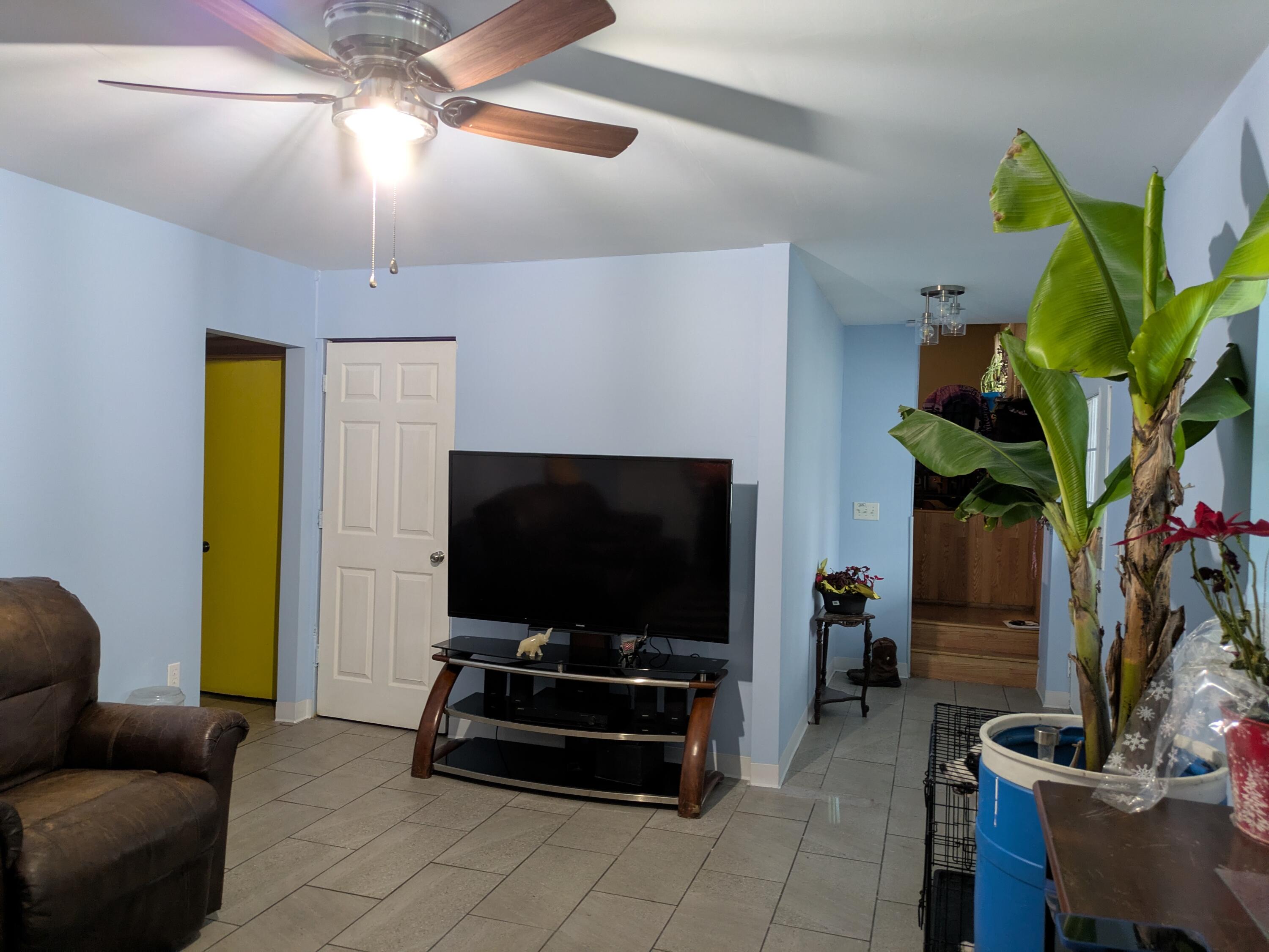 23180 Whitcomb Street Lowell, IN 46356 - Photo 6 of 22 a living room with furniture and a flat screen tv