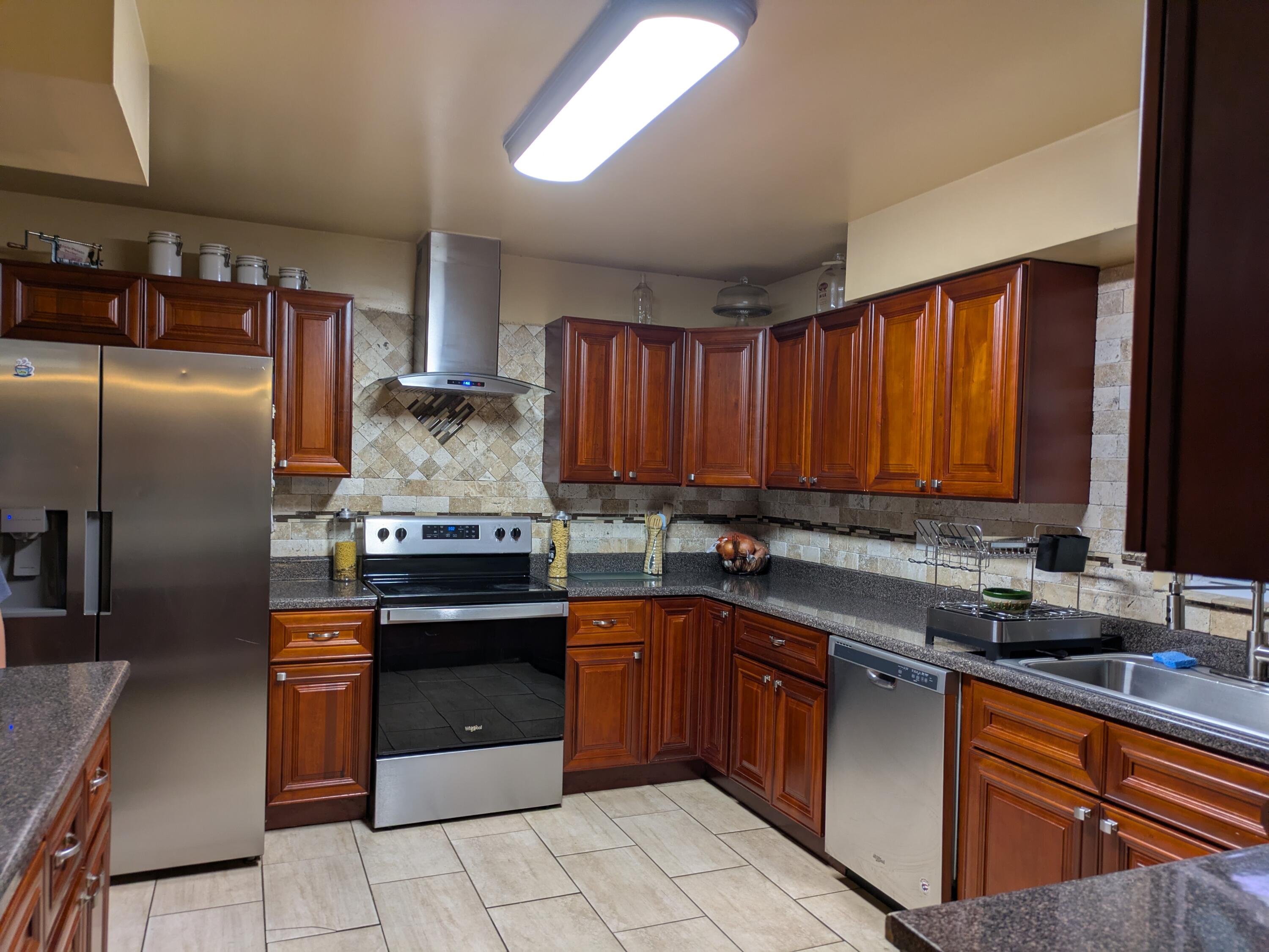 23180 Whitcomb Street Lowell, IN 46356 - Photo 9 of 22 a kitchen with stainless steel appliances granite countertop a sink stove and refrigerator