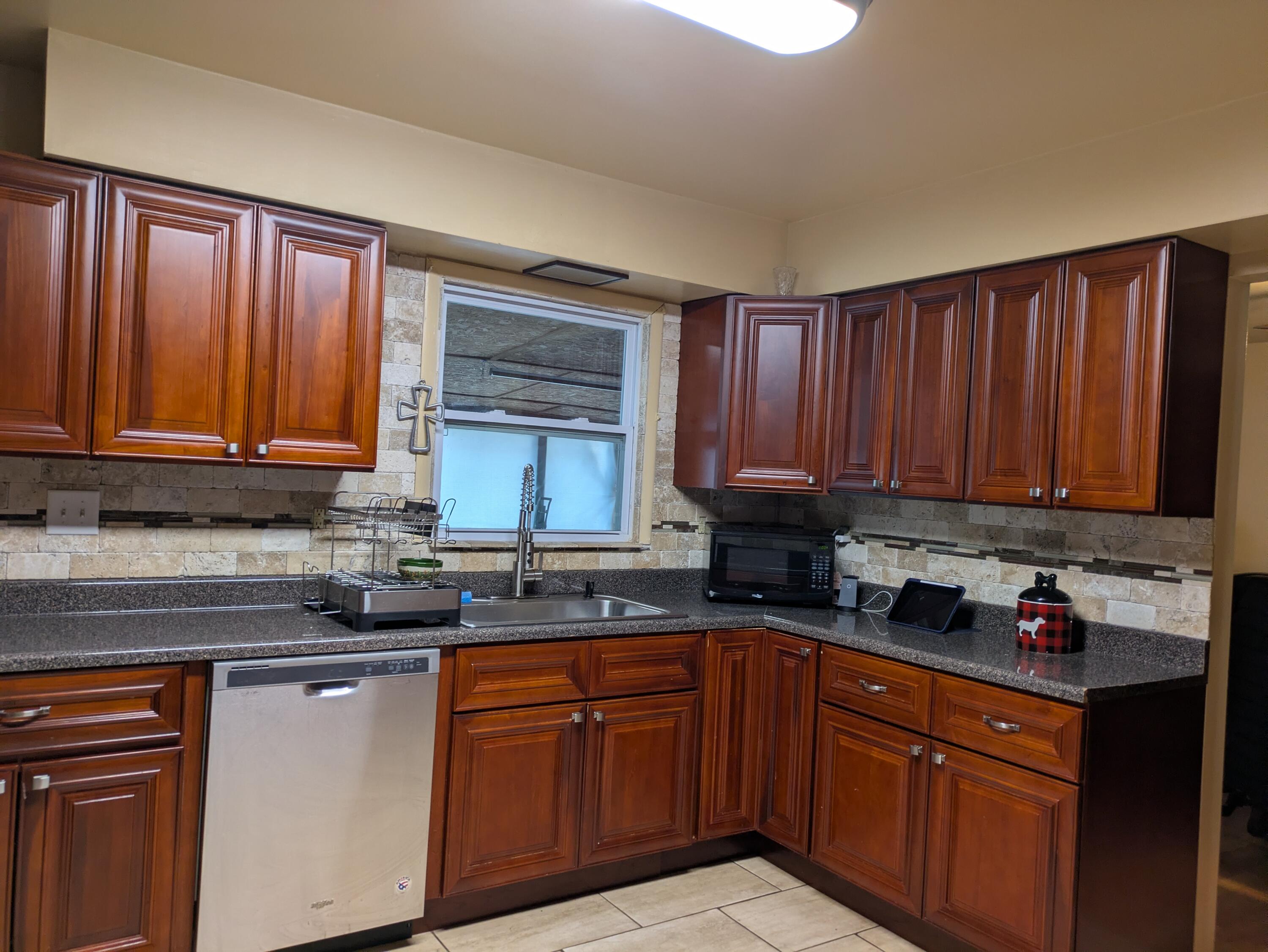23180 Whitcomb Street Lowell, IN 46356 - Photo 10 of 22 a kitchen with stainless steel appliances granite countertop wooden cabinets a sink and dishwasher with wooden floor