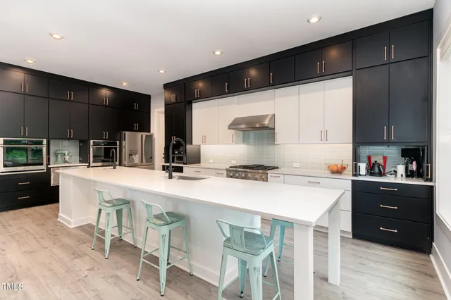 a kitchen with a stove a sink and a refrigerator