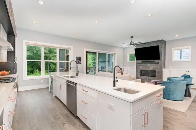 a kitchen with a sink appliances and a large window