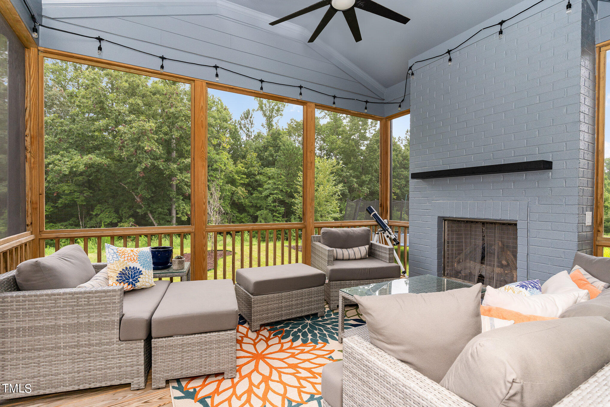 183 Post Oak Road Chapel Hill, NC 27516 - Photo 19 of 51 a living room with furniture a ceiling fan and a fireplace