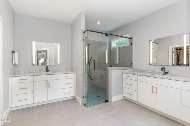 a spacious bathroom with a granite countertop sink mirror and shower