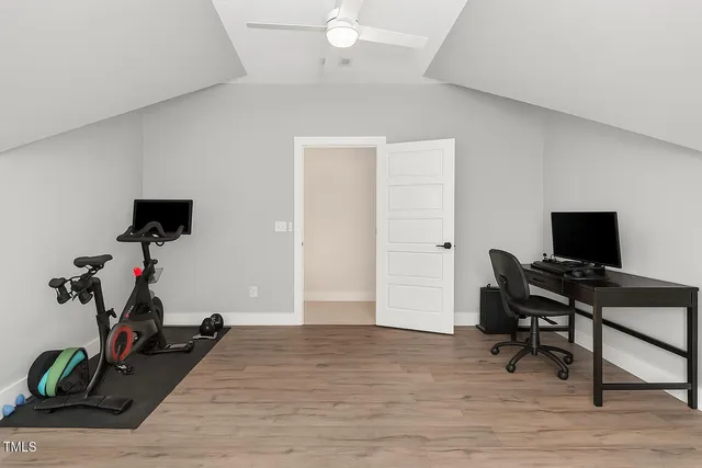 a view of a workspace with furniture and wooden floor