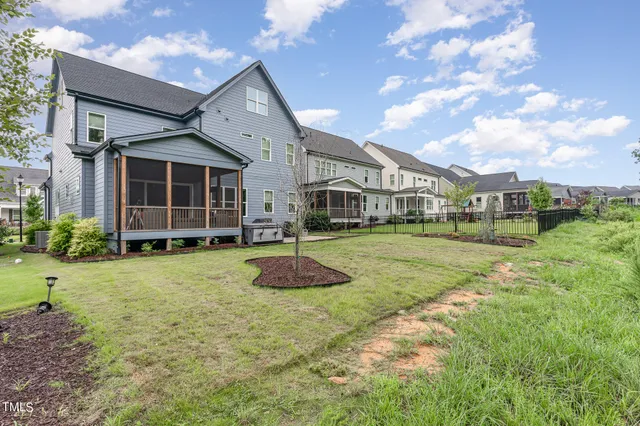 a view of a house with backyard and porch