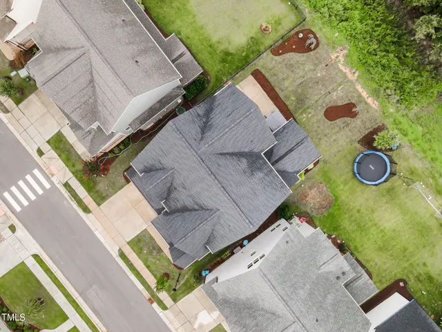 an aerial view of a house with a backyard