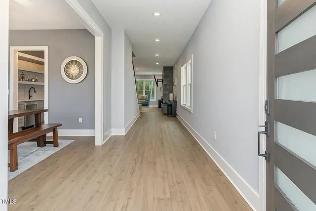 a view of a hallway with wooden floor