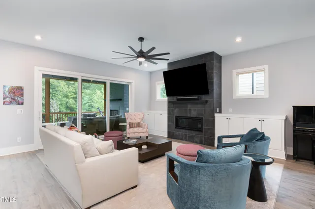 a living room with furniture a fireplace and a flat screen tv