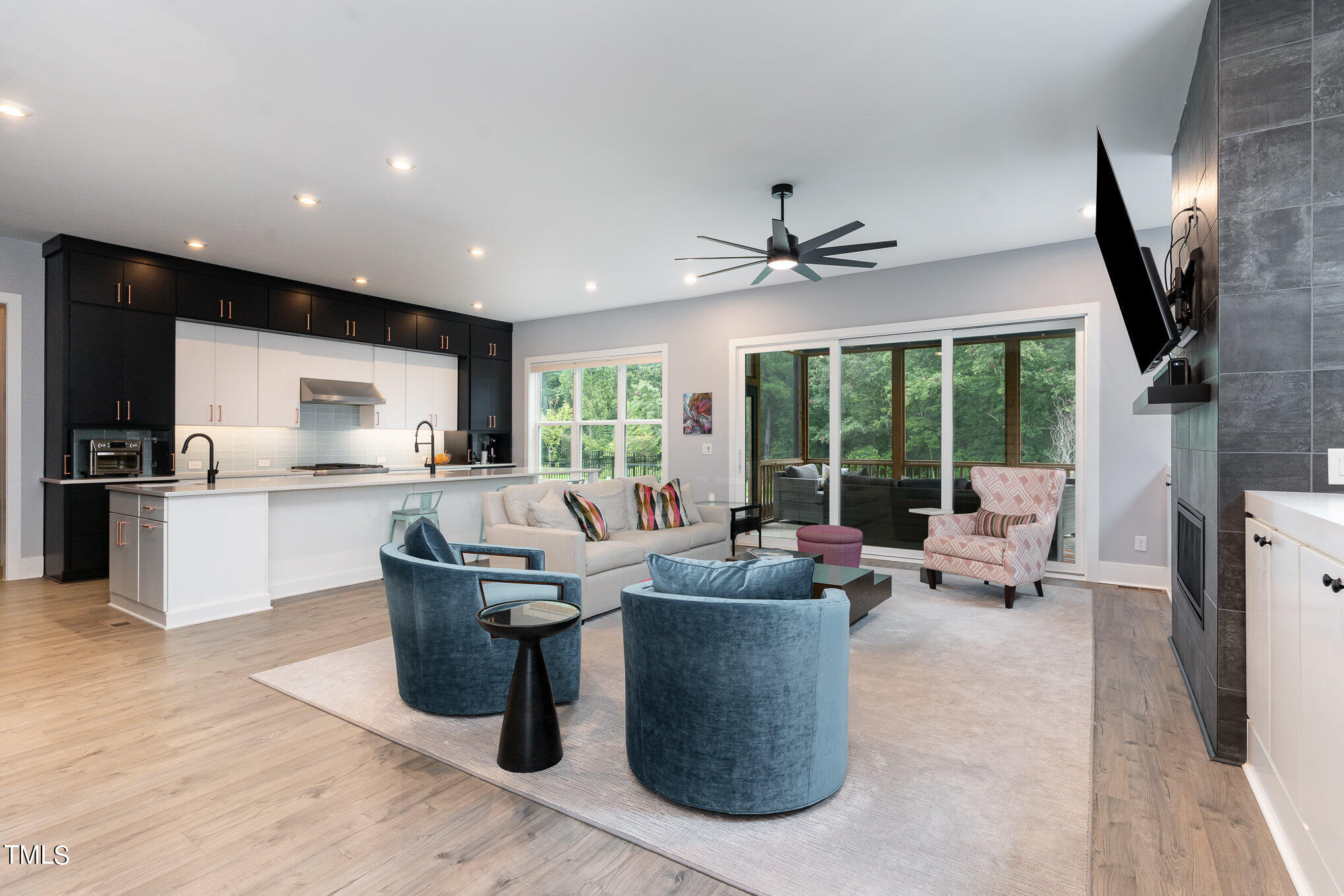 183 Post Oak Road Chapel Hill, NC 27516 - Photo 9 of 51 a living room with couches chairs kitchen view and a large window