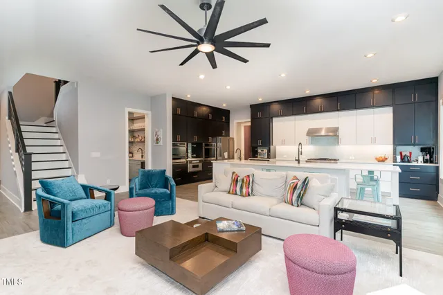 a living room with furniture ceiling fan and a rug