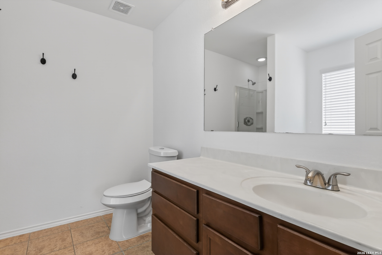 332 Lonestar Gait Selma, TX 78154 - Photo 12 of 24 a bathroom with a sink toilet and vanity