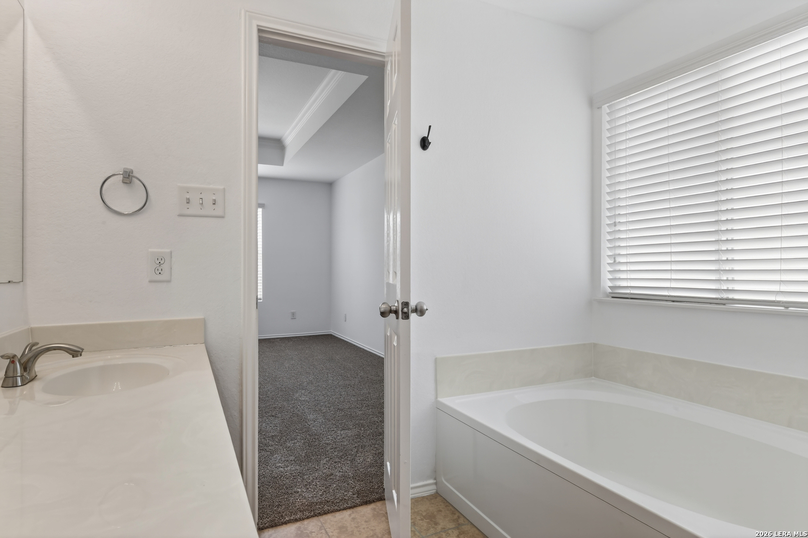 332 Lonestar Gait Selma, TX 78154 - Photo 14 of 24 a bathroom with a tub sink and window