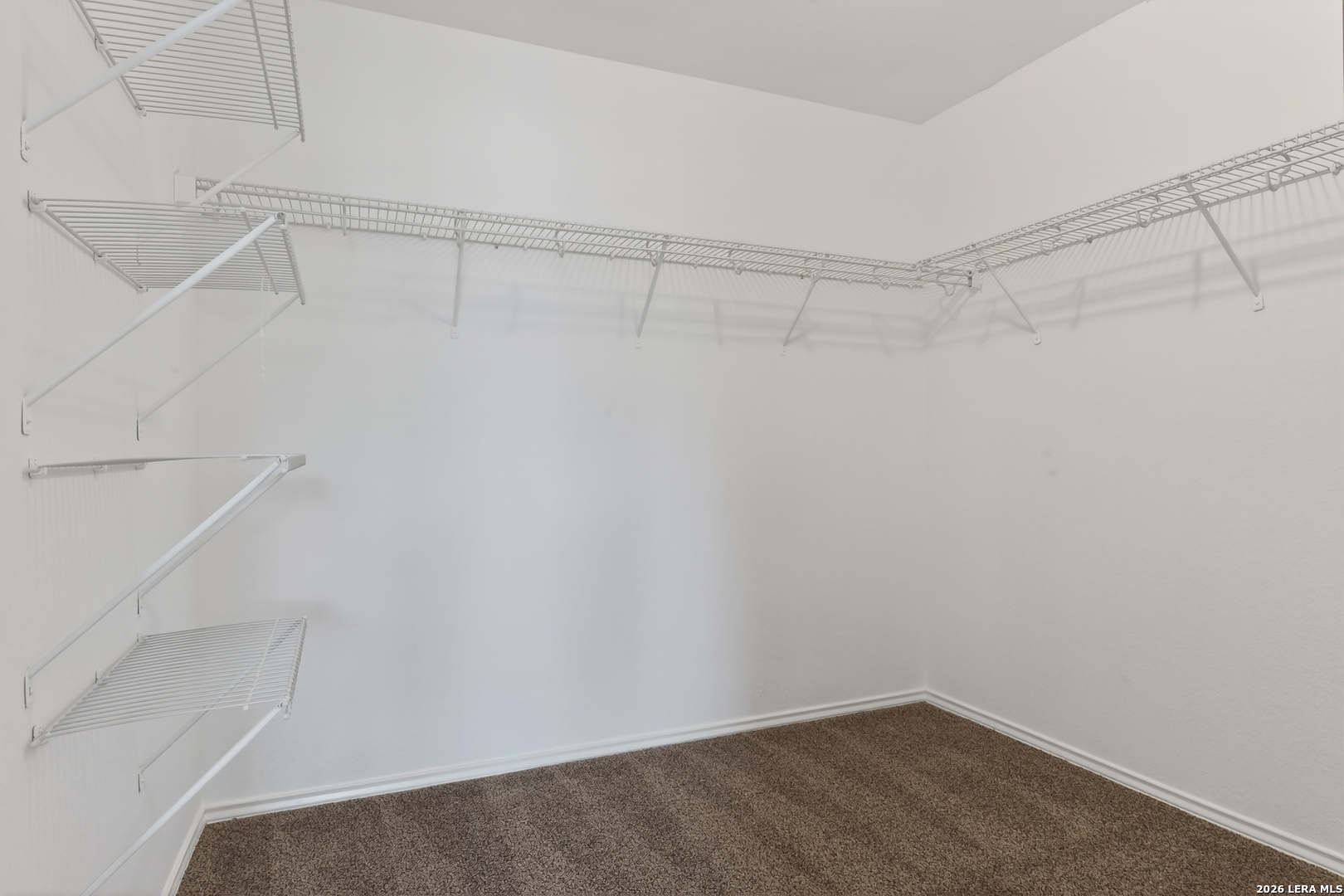 332 Lonestar Gait Selma, TX 78154 - Photo 15 of 24 a view of a room with racks on the wall