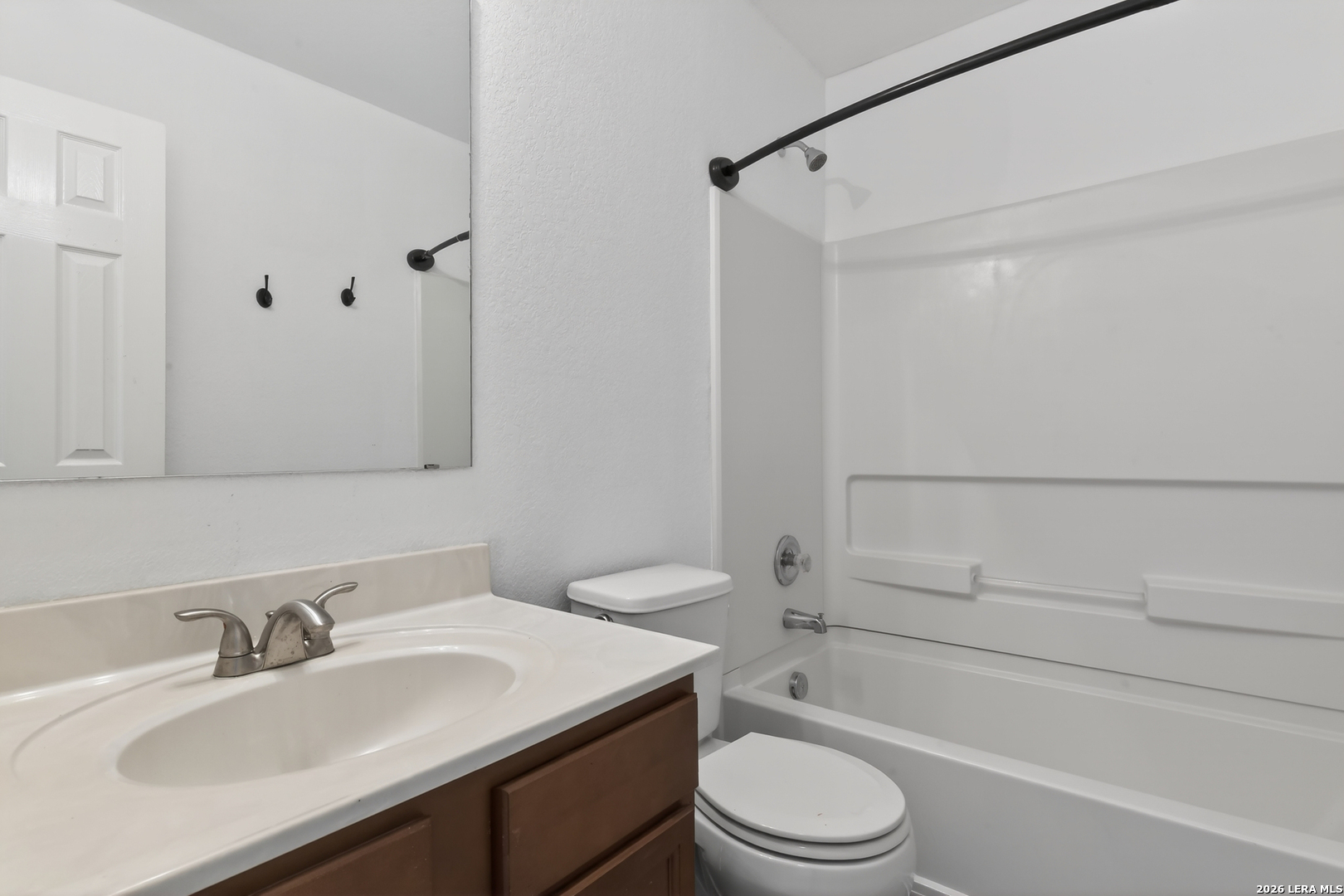 332 Lonestar Gait Selma, TX 78154 - Photo 18 of 24 a bathroom with a granite countertop sink toilet a mirror and shower