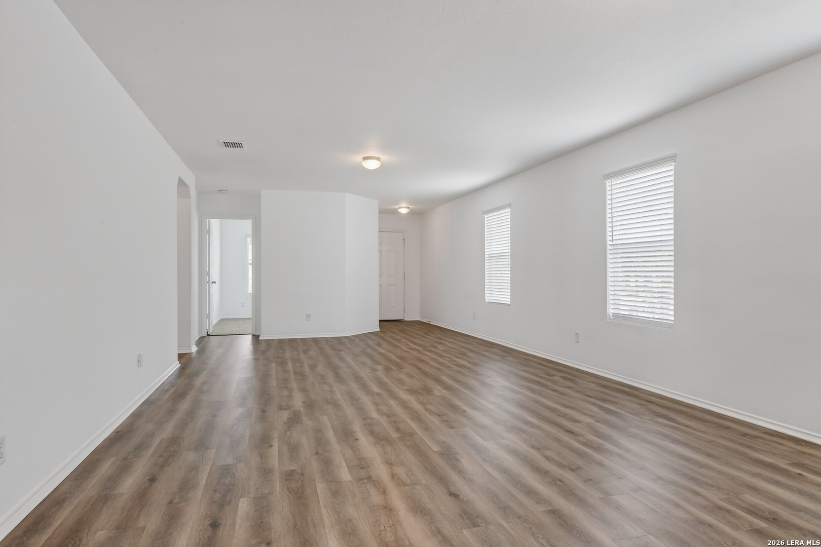 332 Lonestar Gait Selma, TX 78154 - Photo 3 of 24 a view of an empty room with wooden floor and window