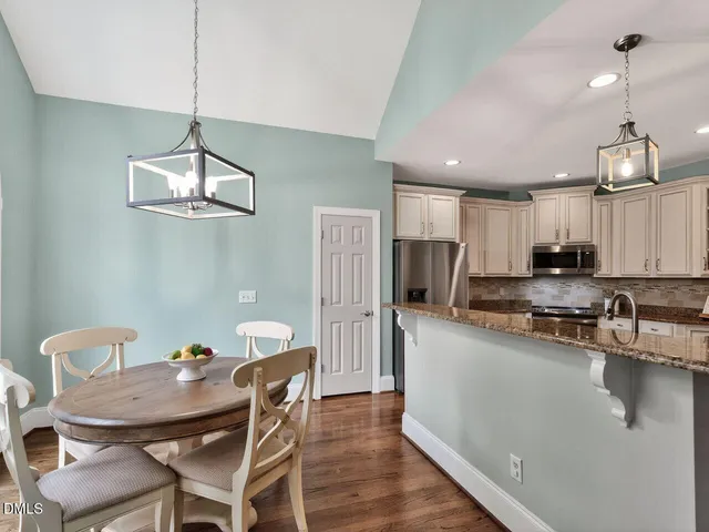 a view of a dining room with furniture wooden floor and chandelier