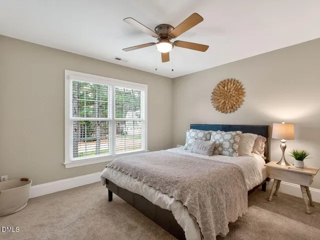 a spacious bedroom with a bed and a window