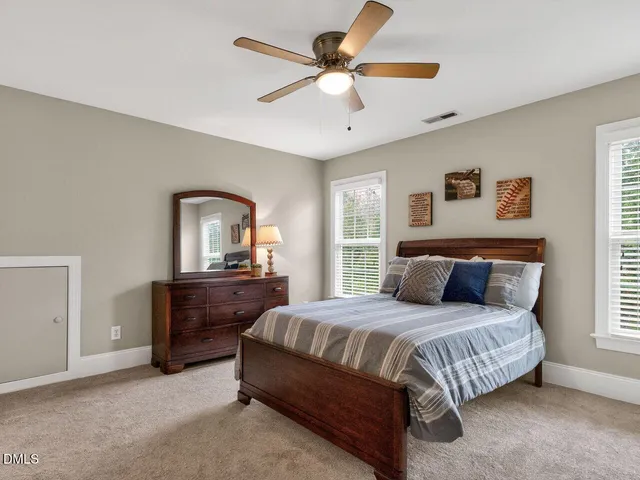 a bedroom with a bed and a dresser