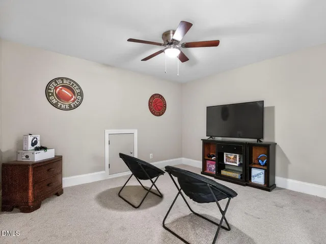 a view of a workspace with furniture and a flat screen tv