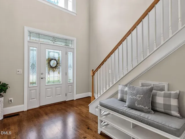 a view of entryway and hall with wooden floor
