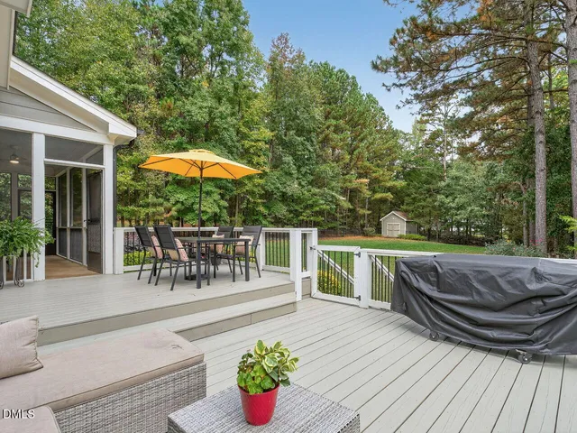 a view of a patio with couches table and chairs and potted plants