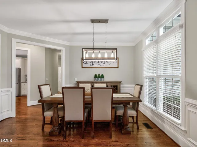 a view of a dining room with furniture window and wooden floor