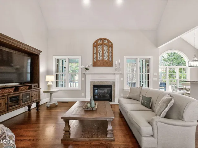 a living room with furniture fireplace and window