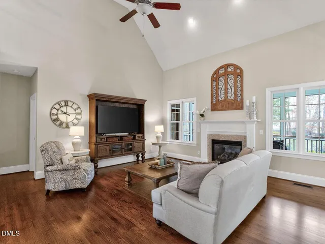 a living room with furniture fireplace and flat screen tv