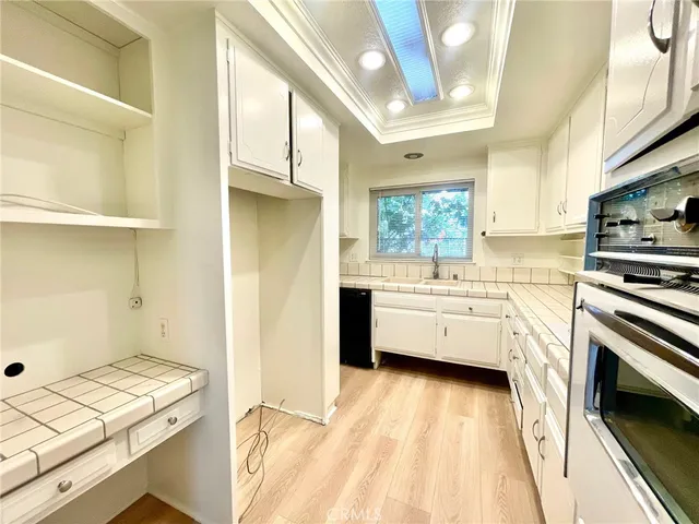 a view of kitchen with stainless steel appliances cabinets and a sink
