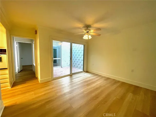 a view of an empty room with closet and a window