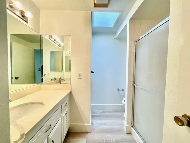 a spacious bathroom with a granite countertop sink and a mirror