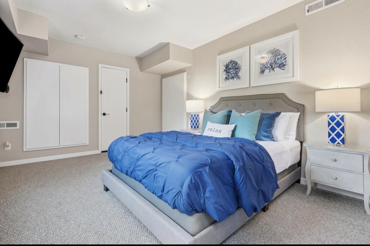 229 Rio Del Mar Boulevard Aptos, CA 95003 - Photo 17 of 27 a spacious bedroom with a bed and a walk in closet