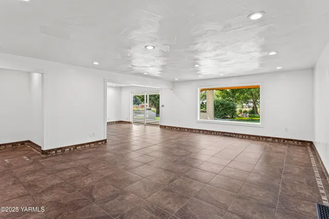 an empty room with windows and entrance