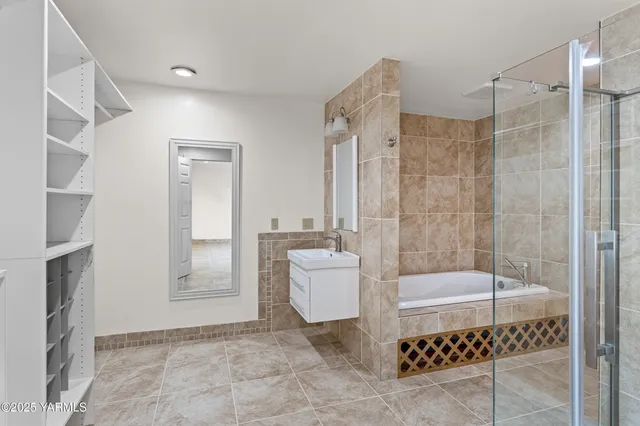 a bathroom with a shower sink and mirror