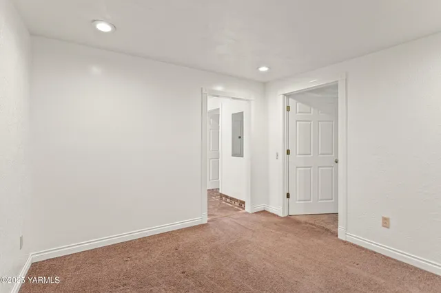 a view of an empty room with closet