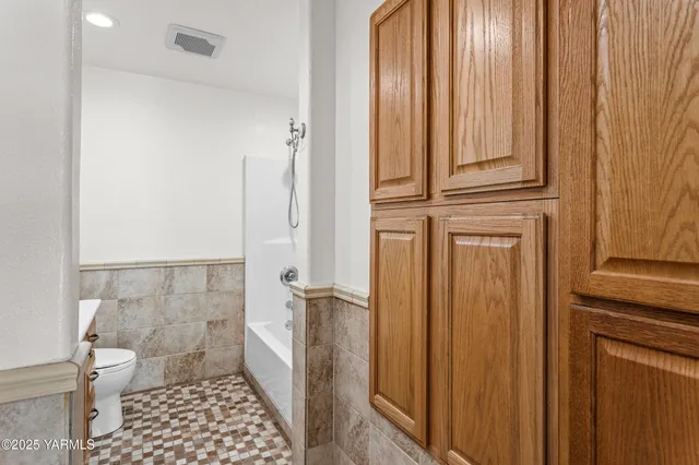 an empty room with wooden floor & closet area