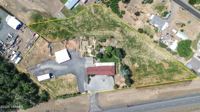 an aerial view of a house with yard