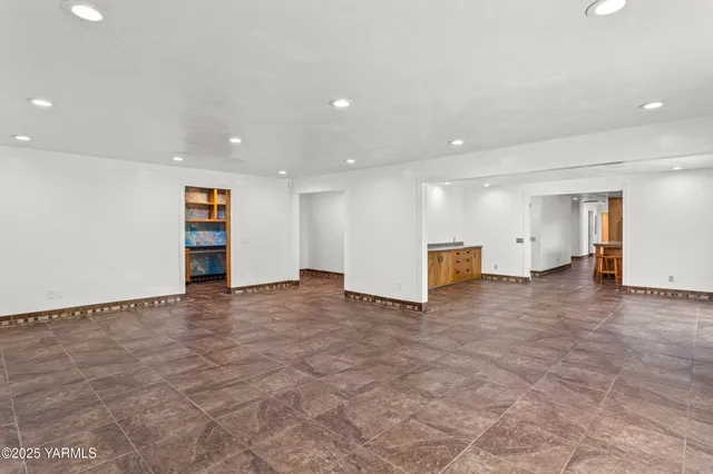 a view of an empty room with a kitchen