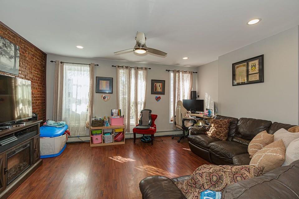 173 12th Street Brooklyn, NY 11215 - Photo 4 of 20 a living room with furniture flat screen tv and wooden floor