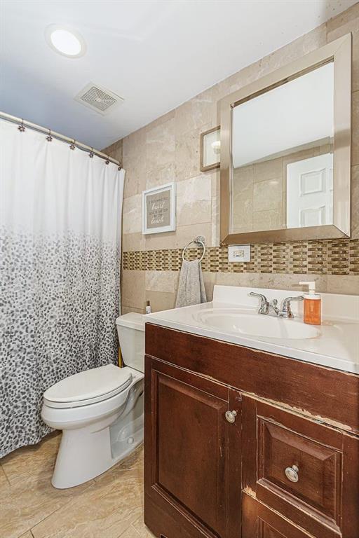 173 12th Street Brooklyn, NY 11215 - Photo 7 of 20 a bathroom with a sink a toilet and a mirror