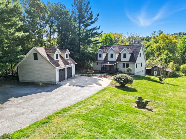 a view of a house with a yard and sitting area