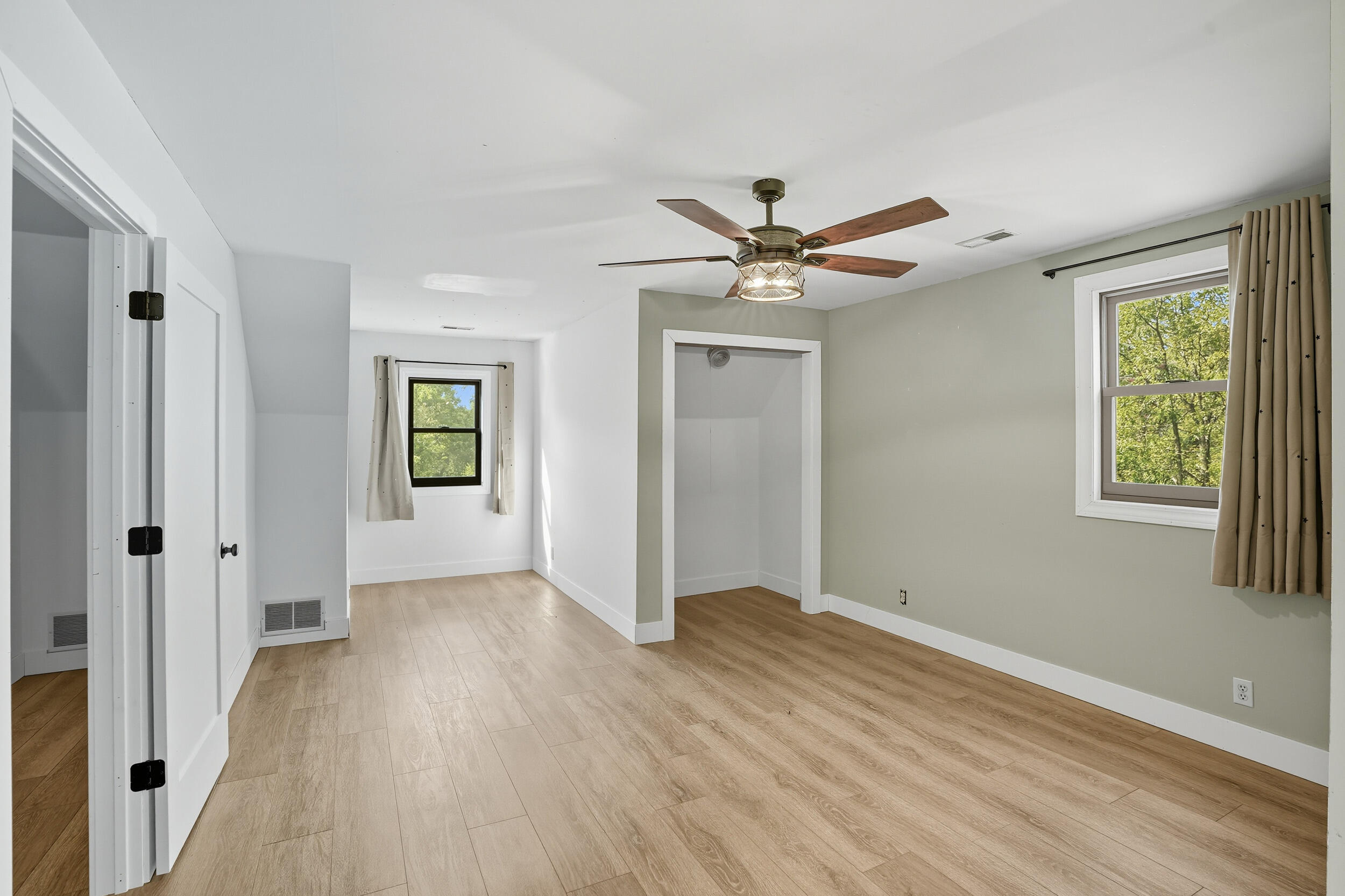 450 East Greening Road Chesterton, IN 46304 - Photo 23 of 56 an empty room with wooden floor a ceiling fan and a window