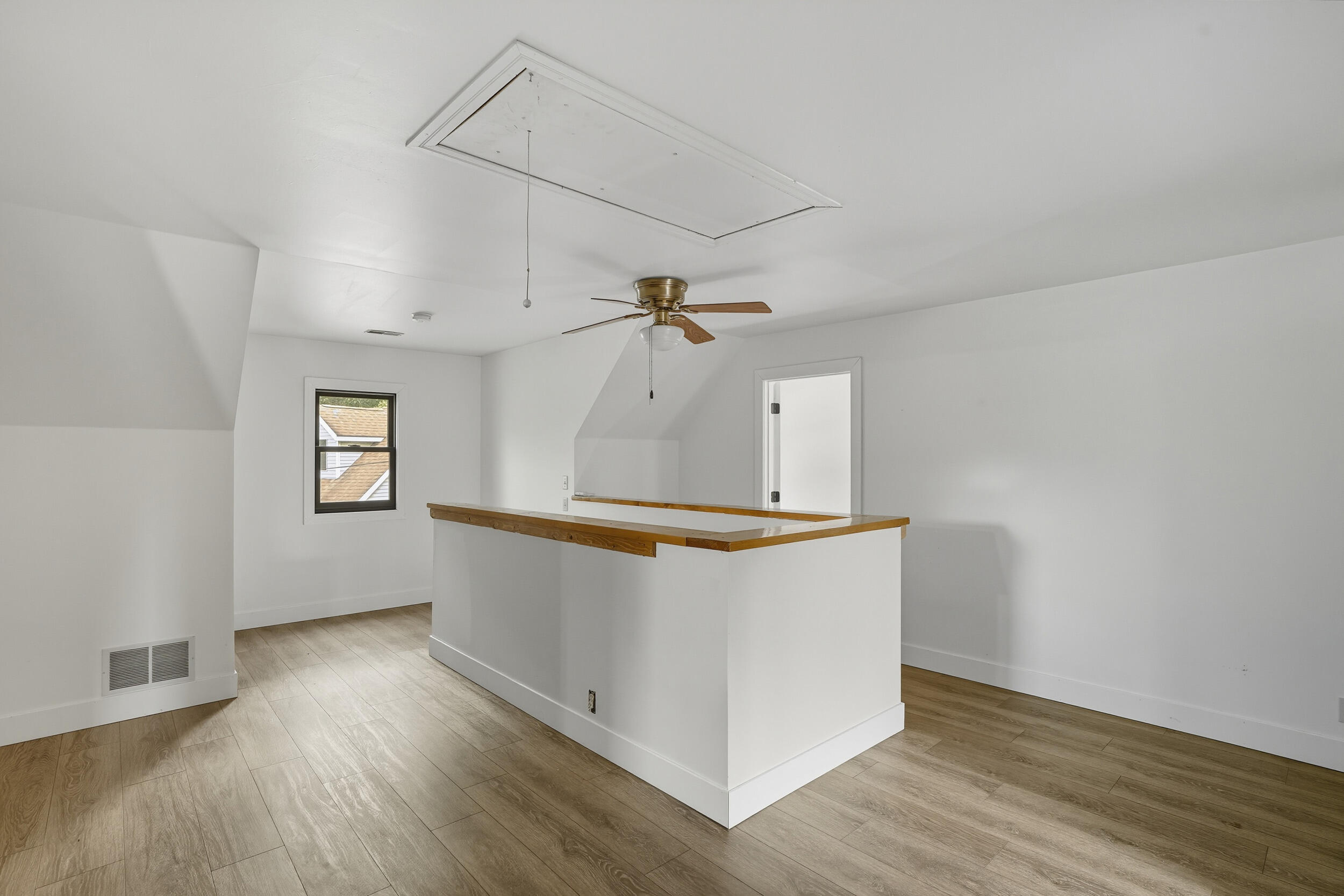 450 East Greening Road Chesterton, IN 46304 - Photo 24 of 56 an empty room with wooden floor ceiling fan and windows